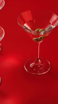 A martini with olives on a glossy red table: a dinner date in Chelsea